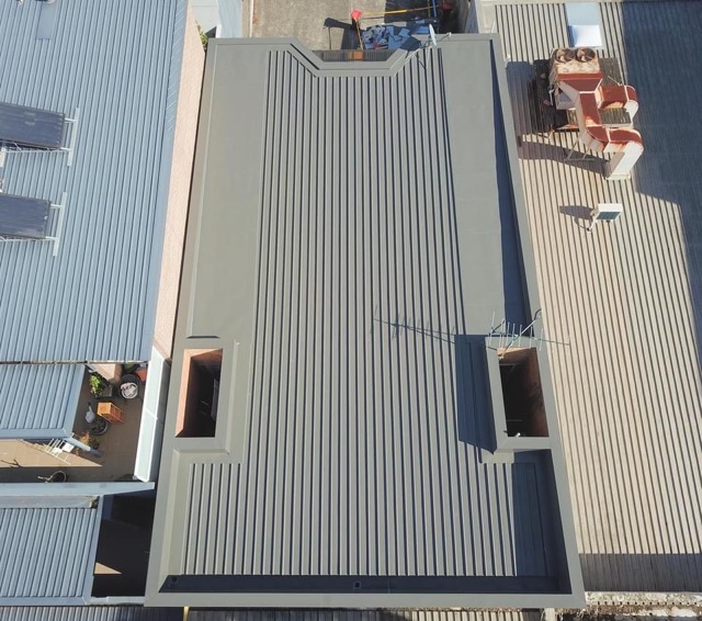 An aerial photo of a restored colorbond roof in Melbourne. It's a light grey colour.