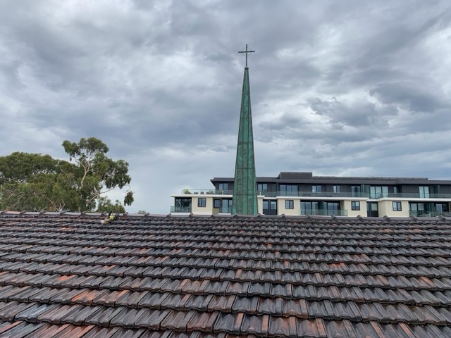 A Church roof showing tiles that have been fully restored