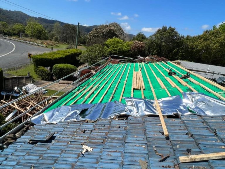 A photo of a roof having its waterproof roof sarking replaced. The sarking is green