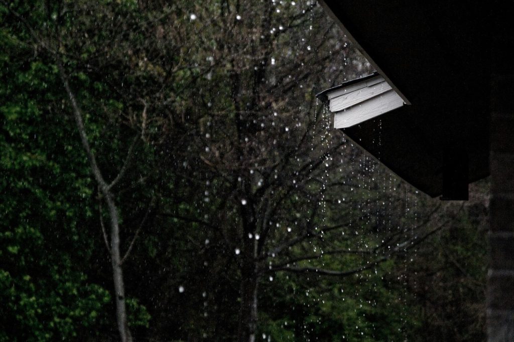 Rain pouring down from a roof during a storm