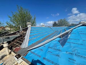 A photo of a roof with brand new, blue waterproof roof sarking