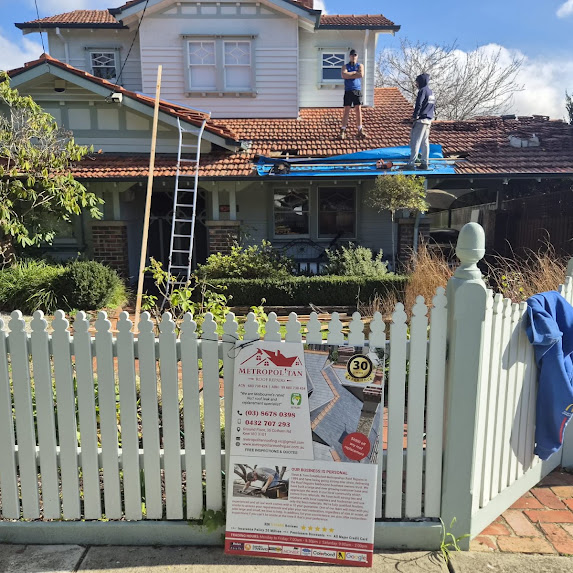 Metropolitan Roof Repairs roofers working on a tiled roof in Melbourne